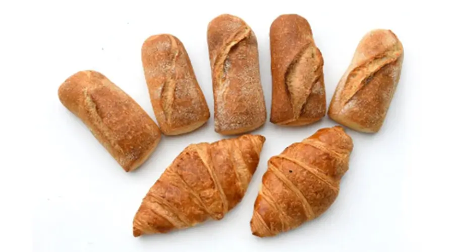 Examples of topping inconsistencies on baked goods including uneven seed distribution and missing toppings