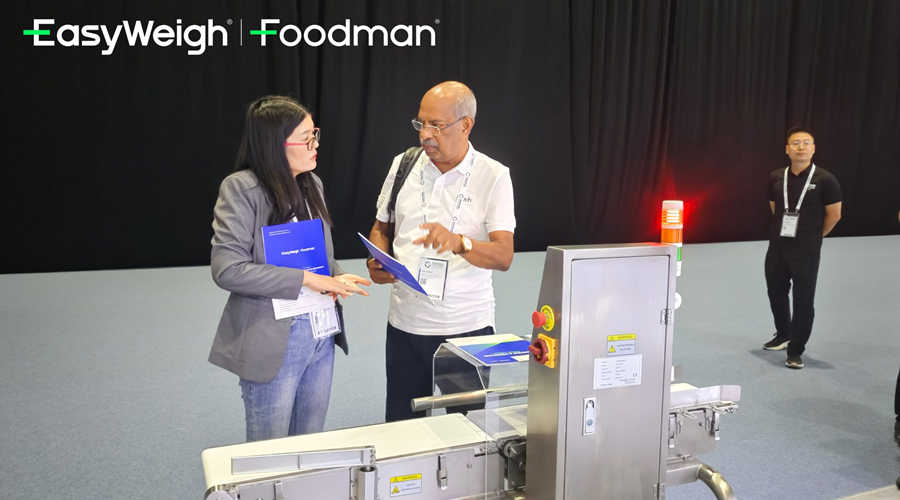 Foodman sales consultant discussing customized solutions with client at Gulfood Manufacturing 2025