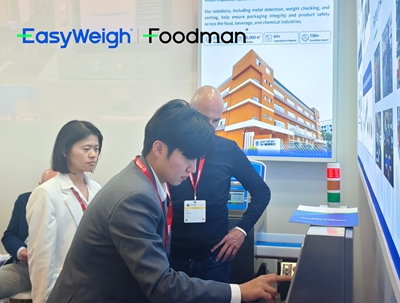 Foodman technician demonstrating the HMI touchscreen of a checkweigher and metal detector combo machine at interpack 2026