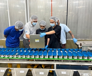 Foodman technician conducting operator training on metal detector settings and calibration procedures at customer plant