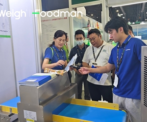 Foodman service technician conducting maintenance training on metal detector control panel for customer operators