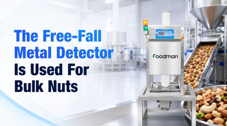 Free-fall metal detector installed on vertical pipeline inspecting bulk nuts with gravity-fed flow and automatic reject valve