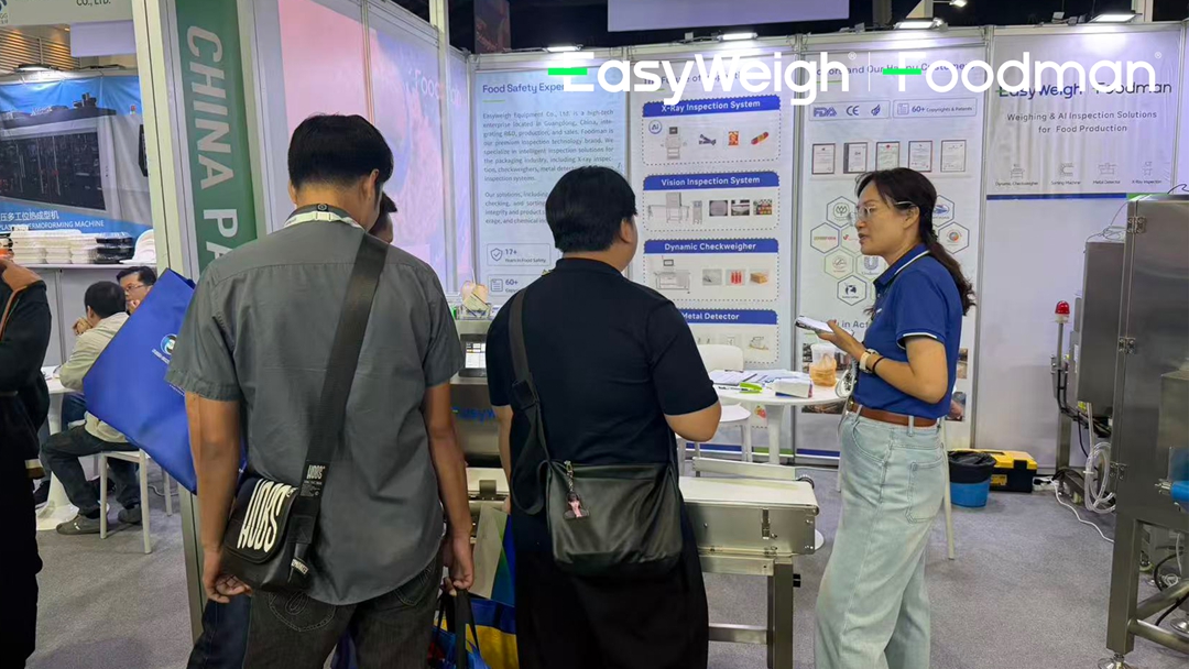 Technical staff demonstrating inspection system operation to potential customers at PROPACK ASIA 2026