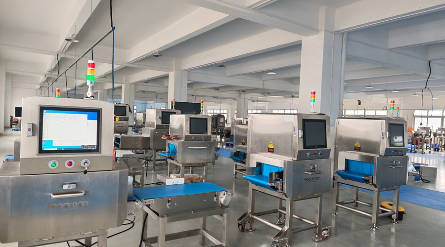 Foodman X-ray inspection machine with stainless steel conveyor and touchscreen interface for food contamination detection