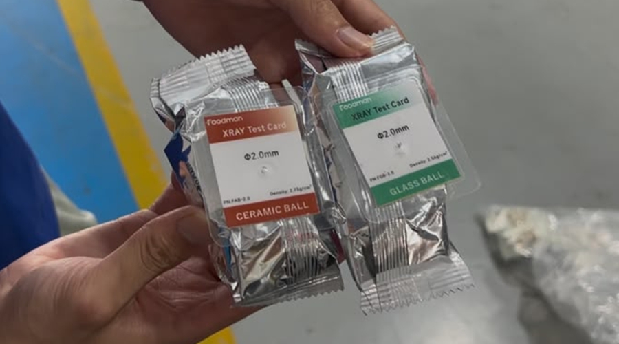 Baked cookies with test card and reference sample positioned for X-ray inspection calibration