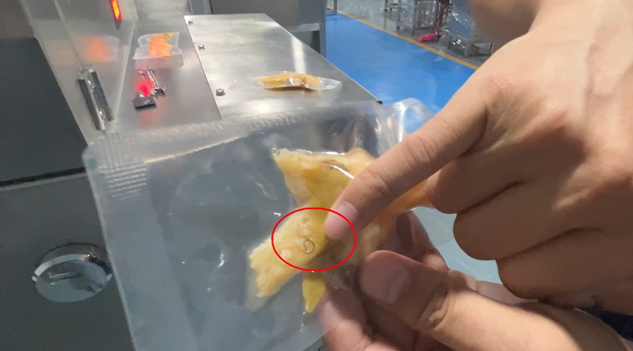 Raw chicken feet with metal wire contaminant visible before X-ray inspection